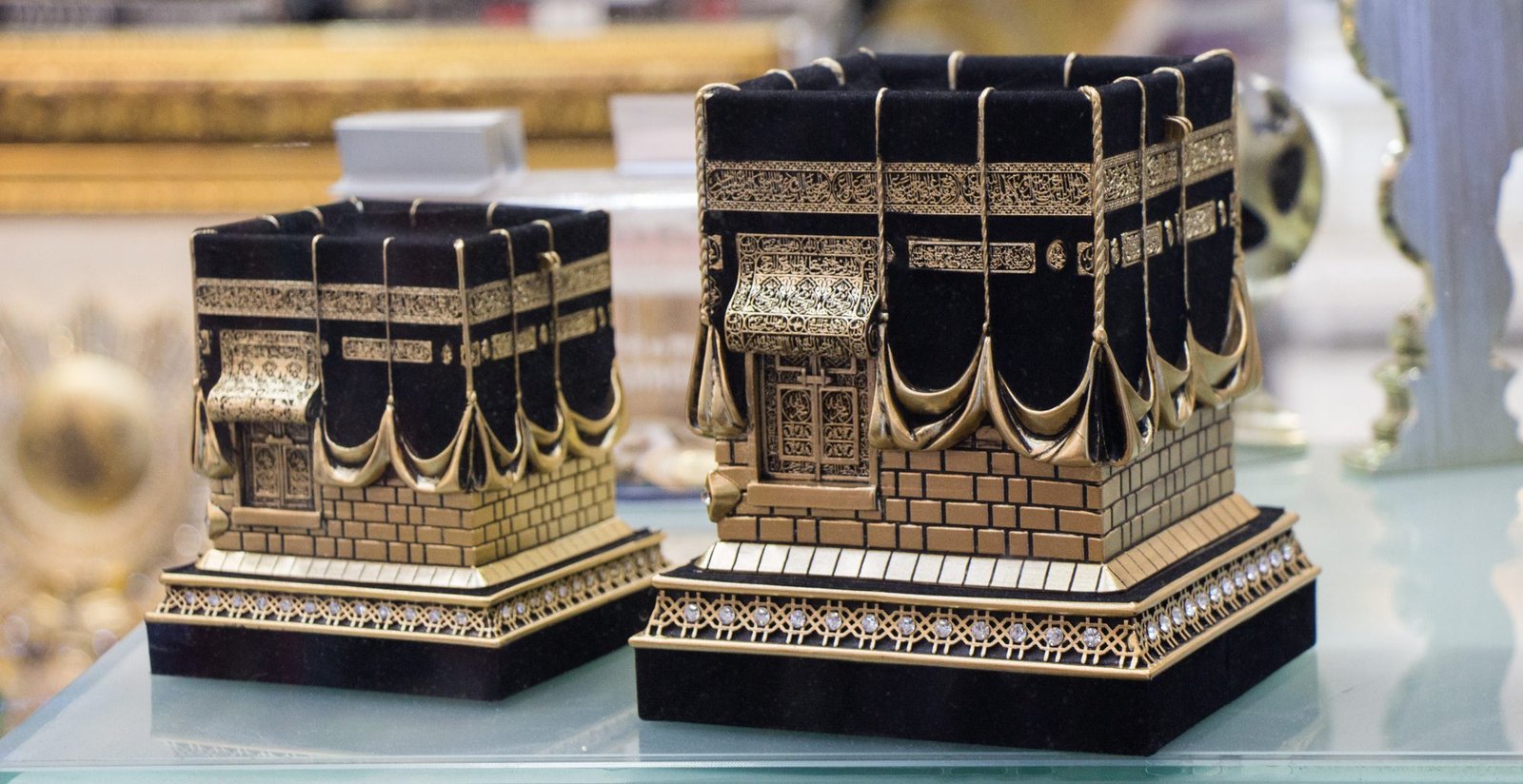 Low angle view of tiny statues representation Kaaba, on the table